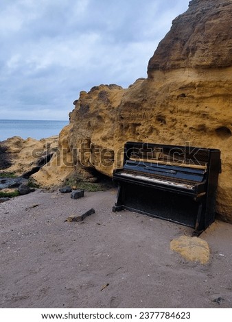 Old piano on the beach near the sea
