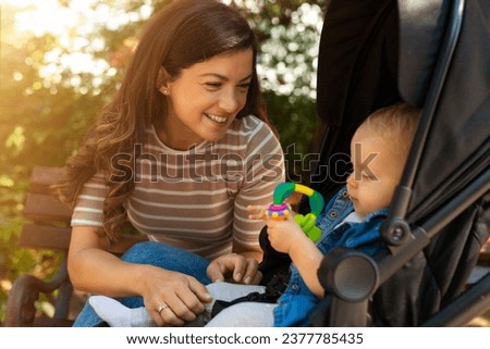 Young mom having fun with her baby in park