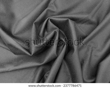 Textile texture background: black woolen fabric for dress, sheep wool clothing, gothic dark soft clothes. Aesthetic tissue with twisted folds, plaid