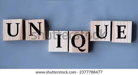 UNIQUE - word on wooden cubes on a gray background. Business concept