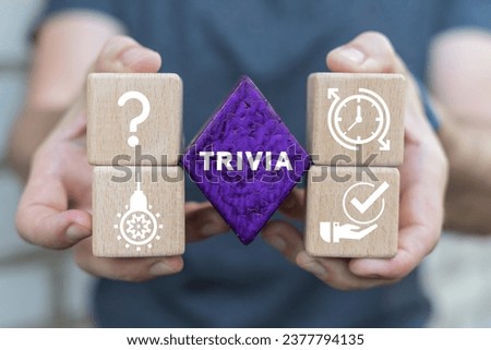 Man holding colorful blocks sees word: TRIVIA. Business, Finance and Economics concept. Trivia Time.