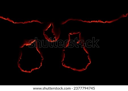 burning paper, glowing edge of paper on a black background Royalty-Free Stock Photo #2377794745