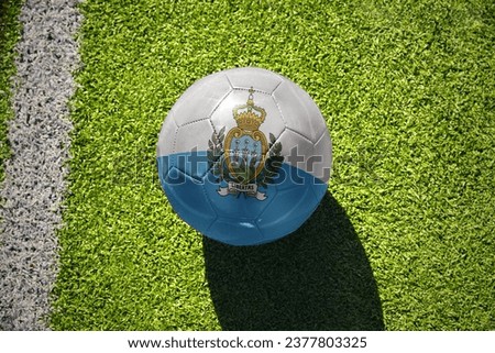 football ball with the national flag of san marino on the green field near the white line