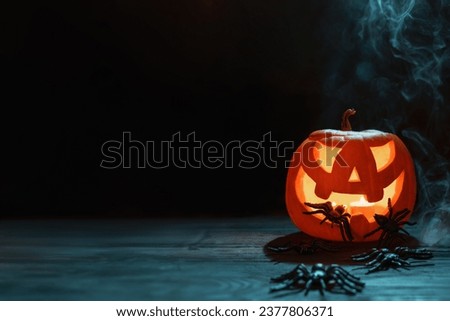 Halloween pumpkins festive background. Moonlight and candlelight. Jack-o-lantern halloween mystic background with mist, spiders, bat and fog, bats.