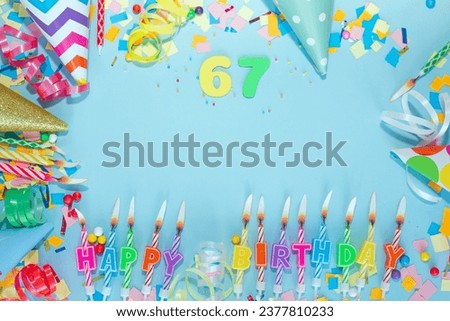 Top view card happy birthday with number  67. Copy space. Postcard holiday anniversary. Happy birthday multicolored background for mensto text, with a numeral with pretty decorations in pastel colors.