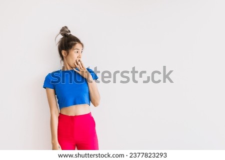 Shocked and surprised portrait of cheerful asian woman isolated on white.