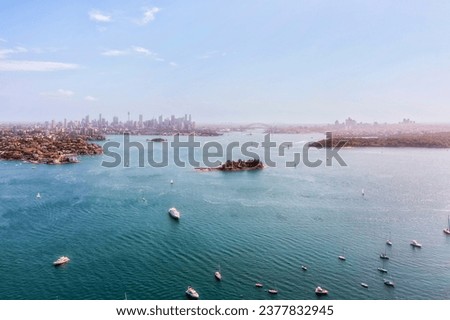 Greater Sydney Eastern suburbs and city CBD on shores of Sydney harbour in aerial view from Shark Island. Royalty-Free Stock Photo #2377832945