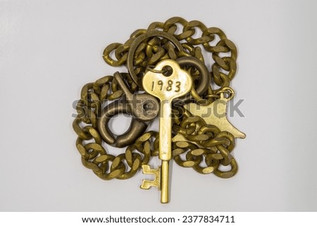 Gold key with engraved numbers on a white background