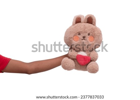 A girl's hand holding a toy rabbit. Toys for toddlers. Banner, poster design elements.