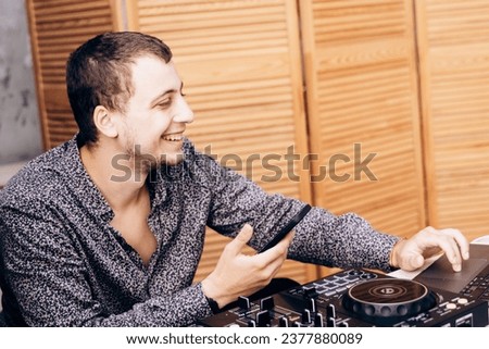 DJ plays music at remote control during party
