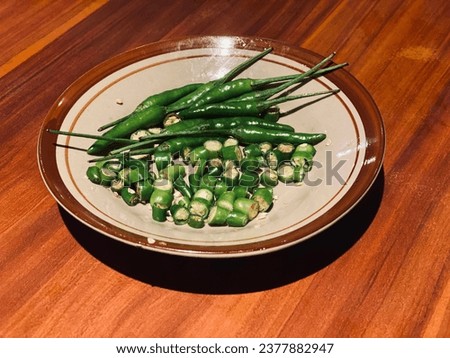close up of green chili and chili slice on the traditional plate stock image