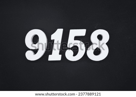 Black for the background. The number 9158 is made of white painted wood.