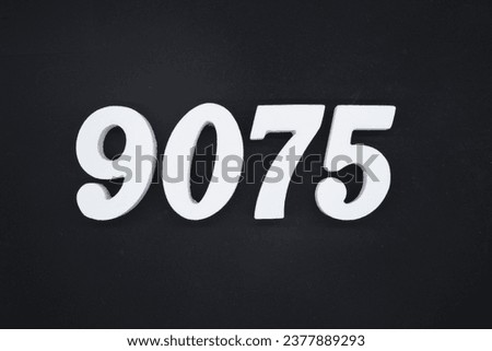 Black for the background. The number 9075 is made of white painted wood.