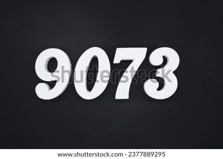 Black for the background. The number 9073 is made of white painted wood.