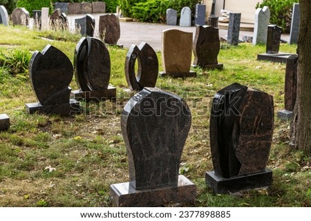 Gravestones are displayed for sale at a stonemason on the lawn Royalty-Free Stock Photo #2377898885