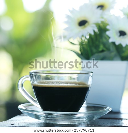 Black coffee in a glass on the table. Coffee Espresso with flower