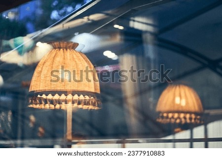 Vintage floor lamp with yellow light is reflected in a dark window with space to copy. High quality photo