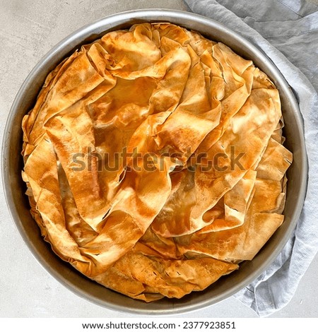 Filo pastry pie pan, zucchini Greek pie top view, mediterranean food picture