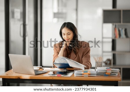 Asian businesswoman working on documents at office