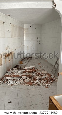 Spain, October 18, 2023: the beginning of repairs in the kitchen, the dismantling of tiles from the walls Royalty-Free Stock Photo #2377941489