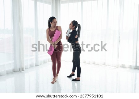 Couple woman enjoy making yoga or fitness exercises. Woman making yoga with coach or personal trainer for health or active lifestyle.