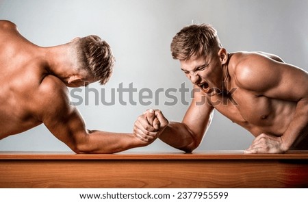 Men measuring forces, arms. Hand wrestling, compete. Hands or arms of man. Arm wrestling. Two men arm wrestling. Rivalry, closeup of male arm wrestling. Two hands.