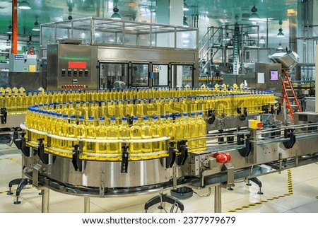 Cooking oil or Sunflower oil in the bottle moving on production line, factory in Ho Chi Minh city, Vietnam Royalty-Free Stock Photo #2377979679