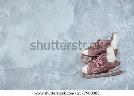Vintage ice skates on concrete background. Retro style filtered photo