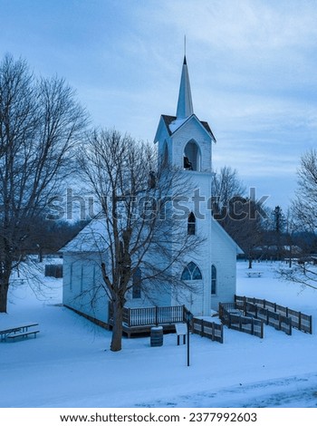 The photo showing the church surrounded by snow and in winter looks very beautiful.