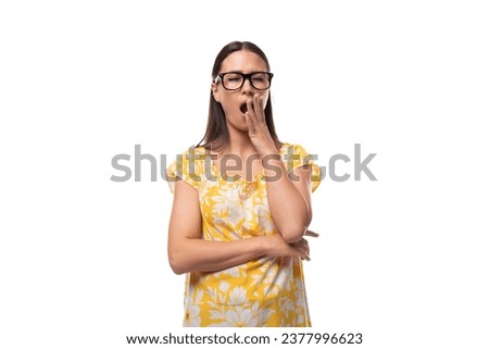 young pretty brunette lady with glasses yawns on white background