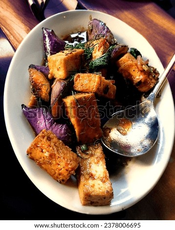 A fancy Vegan Dish meal - made out of (Tofu, aubergine, purple cabbage, sweet peppers and spices Royalty-Free Stock Photo #2378006695