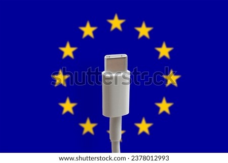 USB C charging cable on a EU flag background. USB Type C is a universal connector