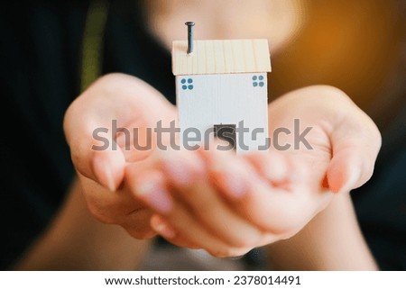 Hand hold small wooden house. Real estate concept. New house concept.