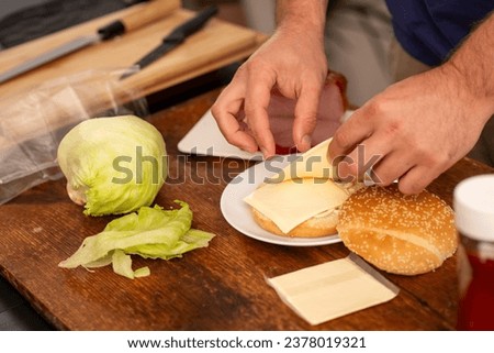 male hands preparing a sandwich
