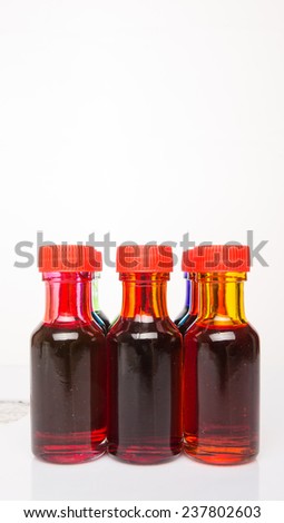 Different color variety of liquid food color additives over white background 