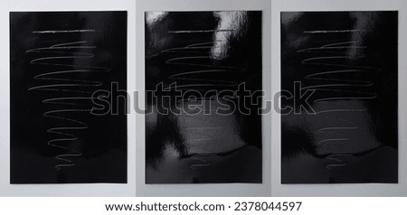 three empty dark shiny Photopaper pieces on white background with deep scratches, nice photo or poster overlay.