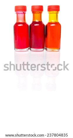 Liquid orange food color additive over white background 