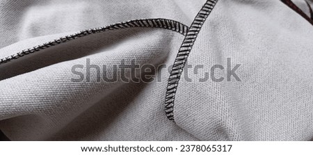 Contrast overlocker stitches of stretchy fabric Royalty-Free Stock Photo #2378065317