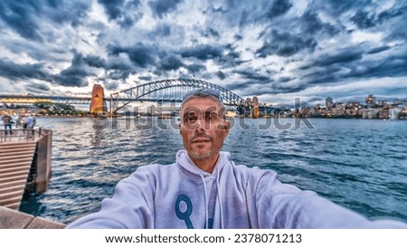 Happy tourist male in Sydney Harbour making selfie.