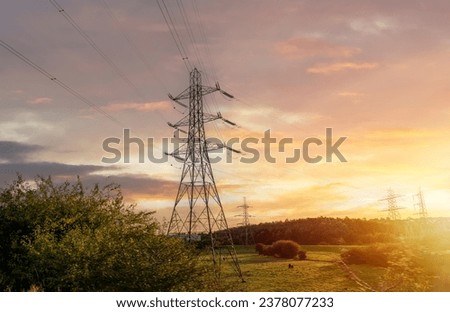 High voltage electric tower line pylon for distribution of electricity from powerstations to customers through national power grid Royalty-Free Stock Photo #2378077233