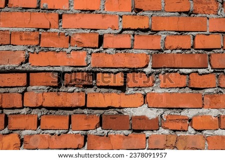 Brick wall background in city.Old and aged red brick wall texture background with vignetting.