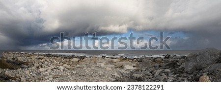 
Panoramic photography on the coast of Alnes facing the Atlantic Ocean. Alnes is a picturesque fishing town on the island of Godoy. Dramatic sky with storm clouds, Norway