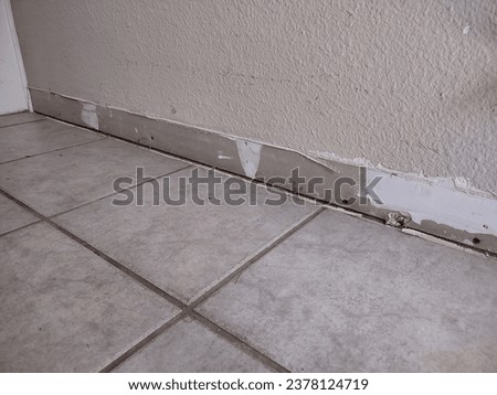 Preparing baseboards after removing old baseboards; installing baseboards after flooring Royalty-Free Stock Photo #2378124719