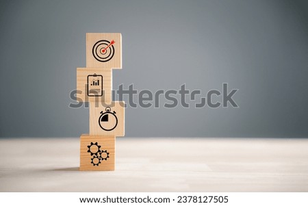 Wooden block step on a table with Action Plan, Goal, and Target icons. Success and business target concept. Company strategy and project management for financial growth.
