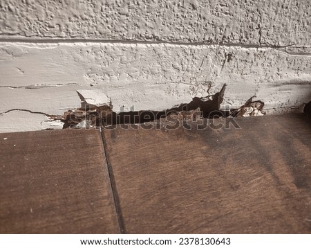 damaged drywall behind baseboard: damaged due to leaking water Royalty-Free Stock Photo #2378130643