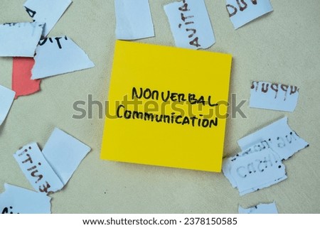 Concept of Nonverbal Communication write on sticky notes isolated on Wooden Table. Royalty-Free Stock Photo #2378150585
