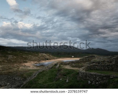 Seascape with cloudy sky and yellow sand in Galicia, Spain
