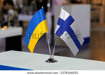 Flags of Finland and Ukraine together at some event or fair. Flags of the two countries as a symbol of cooperation between the two states. Joint business of Ukraine and Finland