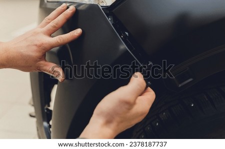 auto mechanic repair car body bumper replacement Royalty-Free Stock Photo #2378187737