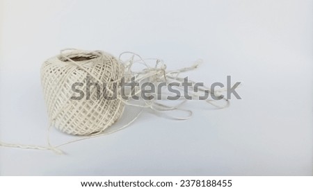 Close up of partially tangled white thread. Isolated on white background 